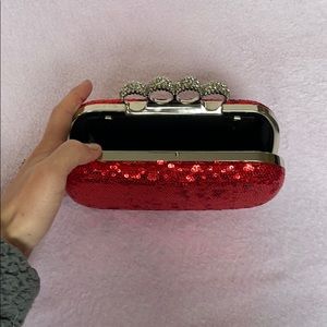 Red “brass knuckle” clutch
